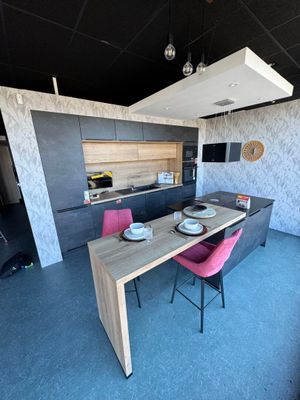 a table and chairs in a room with a black ceiling