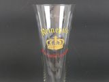 a tall glass with a crown on it sitting on a table