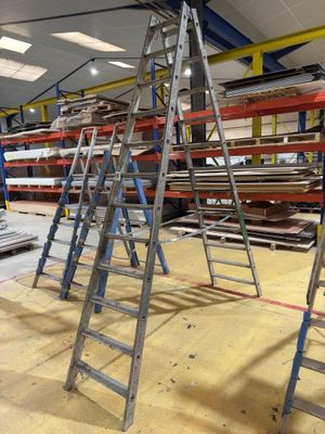 many ladders that are sitting in a warehouse