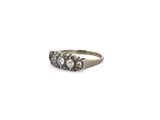 an image of a three stone diamond ring on a white background
