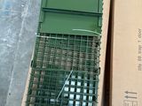 a box with a bird in it sitting on the floor next to a box with a bird in it