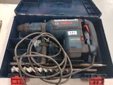 a box with a drill and other tools in it