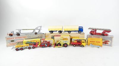 a lot of toy trucks and cars on a white surface