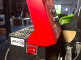 a close up of a machine that has a red handle on it