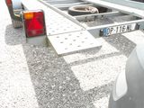 a trailer with a trailer attached to it in a parking lot