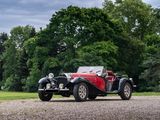 a red and black car driving down a gravel road