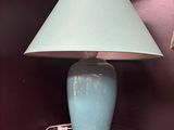 a blue lamp that is on top of a shelf