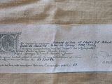 an old piece of paper with a stamp on it sitting on top of a table