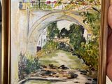 a painting of a bridge over a river in a gold frame
