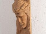 a wooden sculpture of a man with a crown on his head