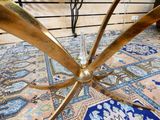 a gold table with a glass on top of it