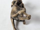 a statue of a man riding on the back of a cow