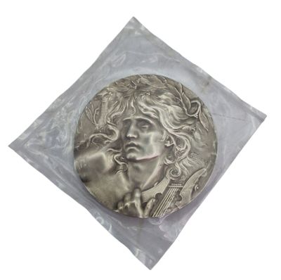 a picture of a silver coin with a man ' s face on it