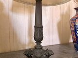 a lamp that is on a table next to a vase