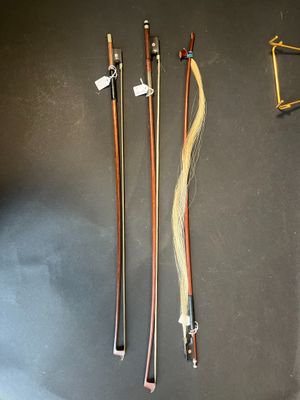 three wooden canes and a pair of scissors on a table