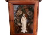 a statue of a woman in a wooden case