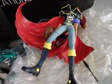 a figurine of a woman in a pirate costume laying on a plastic bag