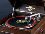 an old record player sitting on top of a wooden table