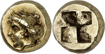 a silver coin with a cross on the front and a face on the back