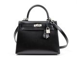 a black leather handbag on a white background