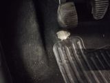 a close up of a car ' s pedals and a steering wheel