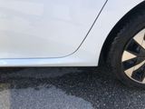 a close up of a tire on a white car
