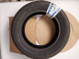 a tire that is sitting on top of a cardboard box