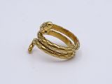 a close up of a gold ring on a white surface