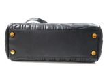 a black leather bag with gold studding on the handles