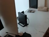 a white desk with a monitor and a mouse on it