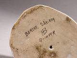 a white vase with writing on it sitting on a table