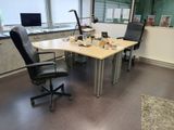 a desk with a chair and a computer on it