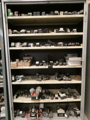 many electronic devices on the shelves in the room