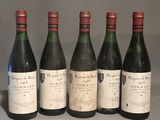 six bottles of wine are lined up on a table