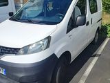 a white van parked in a parking lot next to a white van