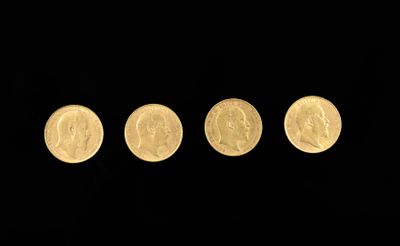 four different types of gold coins in a row on a black background
