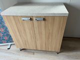 a wooden cabinet with two doors and a counter top
