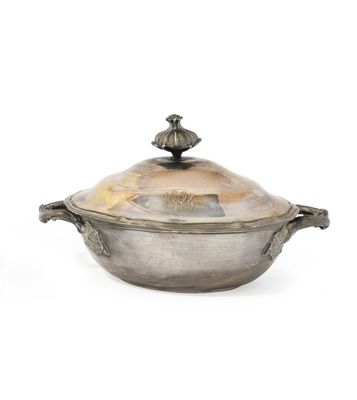an antique silver plated casserole with a lid and handles