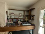 a desk with a computer and books on it