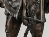 bronze statue of a man with a horse and a dog on a leash