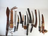 many different types of knives on a white surface