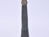a black and gold vase sitting on a white surface
