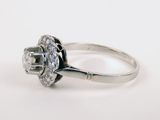 a close up of a diamond ring on a white surface