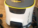 a vacuum that is sitting on the floor next to a hair dryer