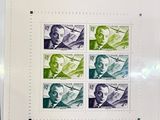 a sheet of stamps with a picture of a man in a suit
