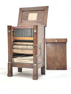 an old wooden chair with a book on top of it