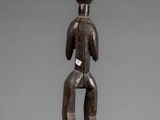a wooden statue of a man with a hat on his head