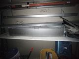 a picture of a metal shelf with some tools on it