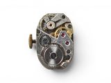 an image of a close up of a watch movement on a white surface