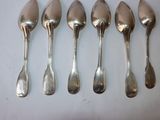 six spoons are lined up in a row on a white surface